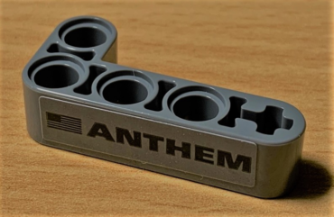 32140pb13 - Technic, Liftarm, Modified Bent Thick L-Shape 2 x 4 with 'ANTHEM' and Black USA Flag Pattern (Sticker) - Set 42078